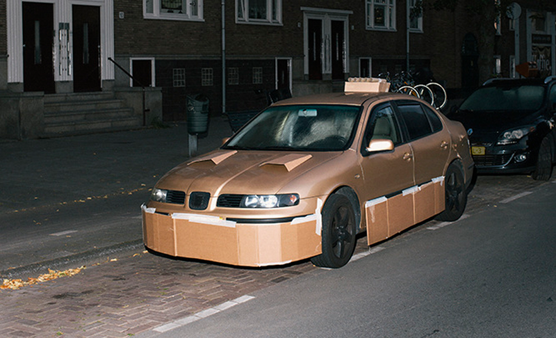 Illustration for article titled This Artist Turns Boring Rides Into Supercars At Night Using Cardboard